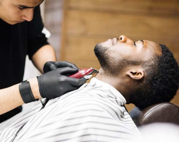 Barber shaving hair on client neck