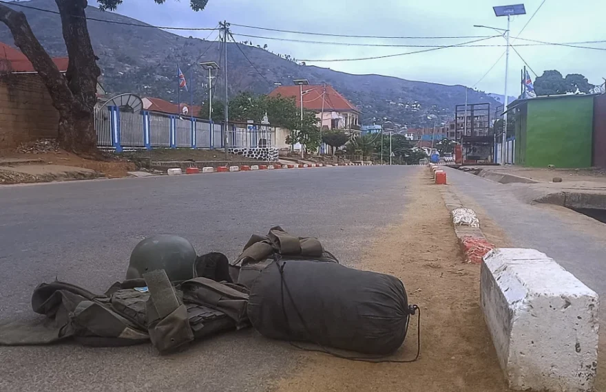 A bullet proof vest carrying a patch with the Democratic Republic of Congo (DRC) flag and a ballistic helmet are left abandoned with other personal belongings in a street in Uvira on December 11, 2025 after M23 take over