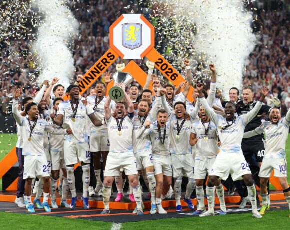 Aston Villa's Scottish midfielder #07 John McGinn and his teammates celebrate with the trophy after winning the UEFA Europa League final football match between SC Freiburg and Aston Villa at Besiktas Park in Istanbul on May 20, 2026. (Photo by Stefano RELLANDINI / AFP)